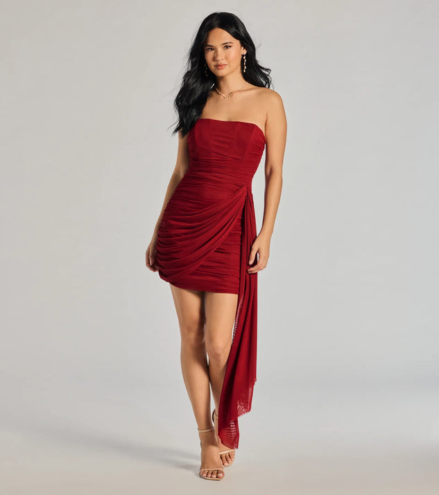 The Kaiya Strapless Bodycon Ruched Mesh Mini Dress in red is a modern red dress featuring trendy details and a stunning design ideal for wedding guest dresses, elegant cocktail looks, or an alluring Valentine’s Day dress.