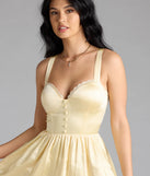 The Kimmie Lace-Up Corset Satin Skater Dress in yellow brings sleek style to any graduation outfit, from cap and gown to after-party.