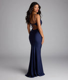 Own the spotlight in the Virginia Cowl Neck Tie-Back Mermaid Formal Dress, a navy blue formal dress crafted to deliver luxe style for summer weddings, Army Balls, or any special event.