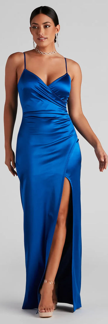 Turn heads at Prom 2025 in this royal blue prom dress, where statement-making details meet the iconic style of the Jolina Wrap Skirt Satin Dress .