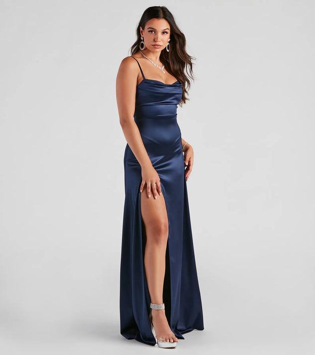 Turn heads at Prom 2025 in this navy blue prom dress, where statement-making details meet the iconic style of the Marissa Formal Satin Cowl Neck Dress .