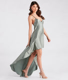 The Jolie Ruffled High-Low Satin Formal Dress is a sage green dress, an essential holiday or NYE dress that pairs chic style with versatility making it perfect for cocktail events, New Year's Eve parties, or as a winter wedding guest look.