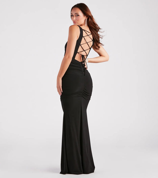 The Evania Formal Lace-Up Mermaid Dress is an elegant black formal dress in a rich seasonal color and with unique design accents that make dressing up for winter parties, holiday balls, or festive gatherings effortless!