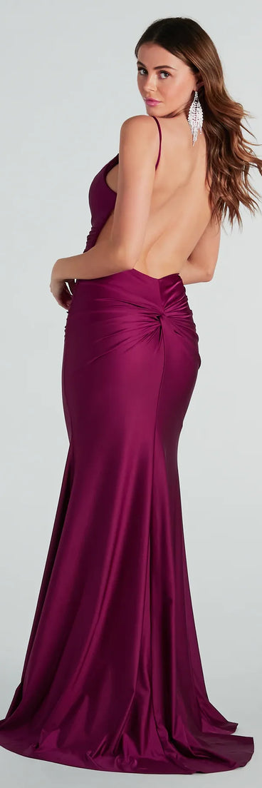 The Reagan Formal Satin Low Back Mermaid Dress is an elegant plum formal dress in a rich seasonal color and with unique design accents that make dressing up for winter parties, holiday balls, or festive gatherings effortless!