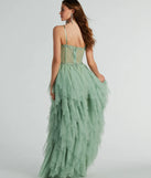The Keyla Floral Applique Tiered Ruffle Tulle Gown in sage is a stunning green prom dress designed to capture attention with its fresh or bold color and effortlessly stylish silhouette.