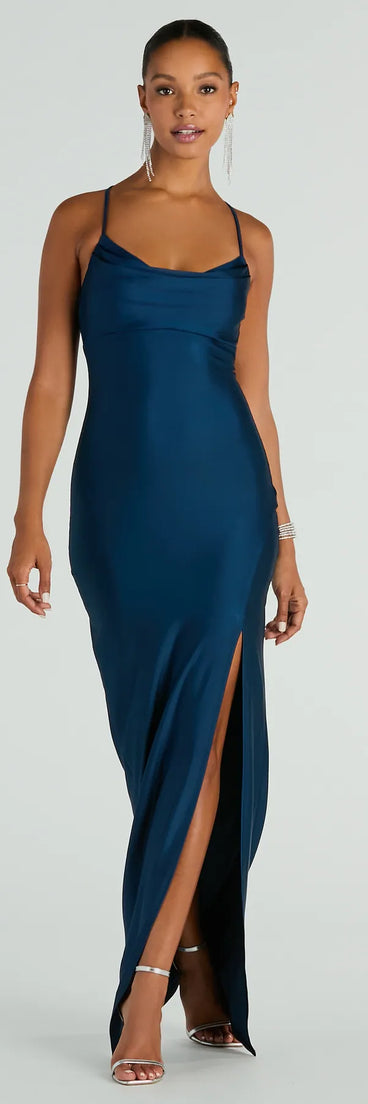 Turn heads at Prom 2025 in this navy blue prom dress, where statement-making details meet the iconic style of the Natalie Cowl Neck Lace Up Slit Formal Dress .