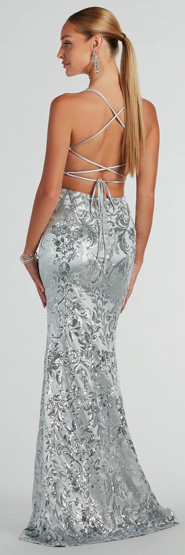 Stand out in a crowd with the Holly Lace-Up Sequin Satin Formal Dress, a glamorous silver sequin dress that sparkles effortlessly as an NYE party gown, wedding guest dress, or must-have evening wear for formal events like military balls and winter formals.