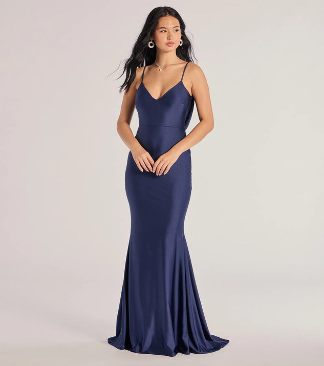 Turn heads at Prom 2025 in this navy blue prom dress, where statement-making details meet the iconic style of the Selena V-Neck Cowl Back Mermaid Formal Dress .