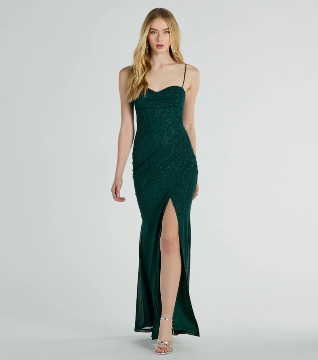 Turn heads at Prom 2025 in this hunter green prom dress, where statement-making details meet the iconic style of the Daleyza Bustier Slit Glitter Column Formal Dress .