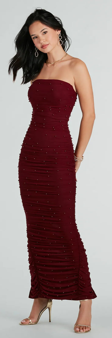 Turn heads at Prom 2025 in this burgundy prom dress, where statement-making details meet the iconic style of the Caterina Formal Strapless Faux Pearl Long Dress .