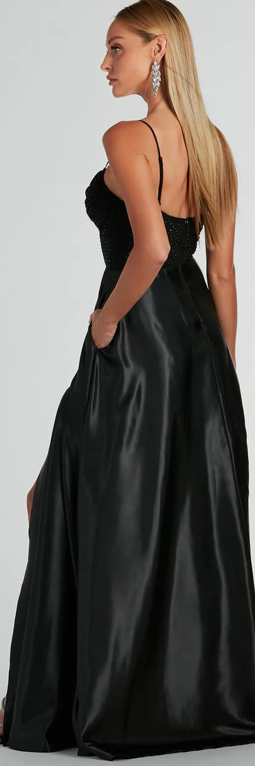 The Ammara Cowl Neck Slit A-Line Satin Formal Dress is a show-stopping black prom dress, offering a sleek, slimming silhouette that enhances your natural beauty for an unforgettable night.