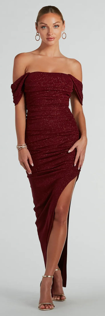 Turn heads at Prom 2025 in this wine prom dress, where statement-making details meet the iconic style of the Kairi Off-The-Shoulder Glitter Mesh Formal Dress .
