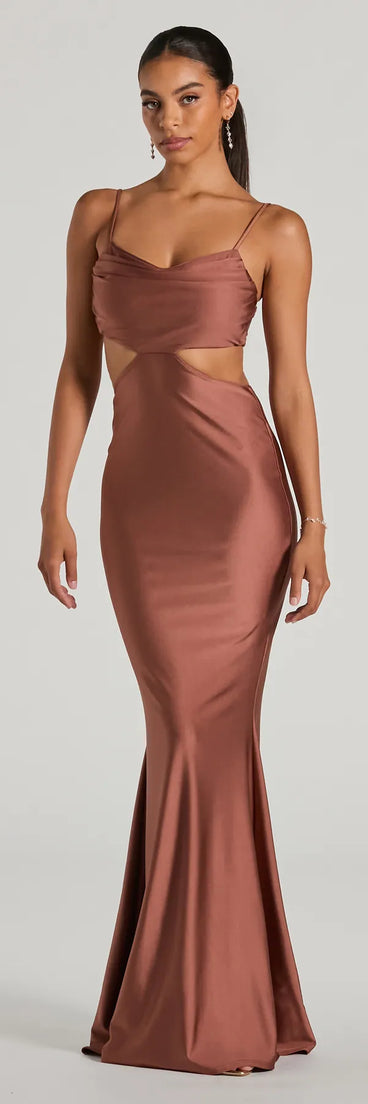 Turn heads at Prom 2025 in this mocha prom dress, where statement-making details meet the iconic style of the Jasmin Cowl Neck Cutout Mermiad Formal Dress .