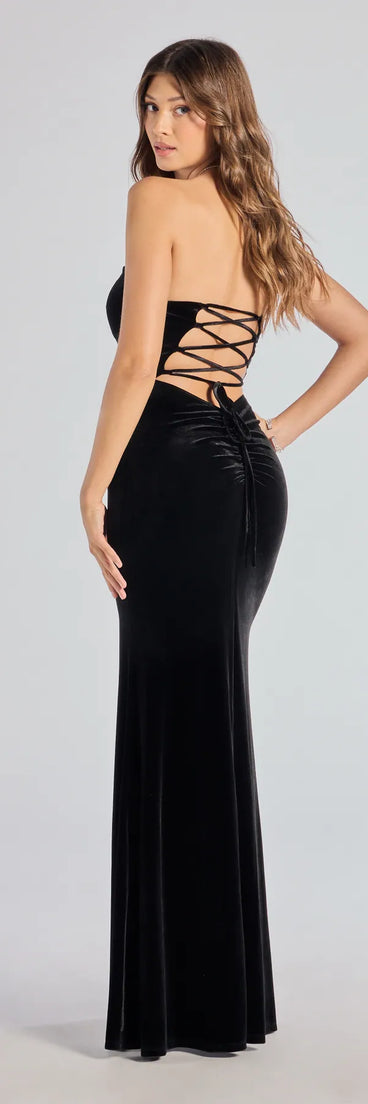 The Margo Velvet Strapless High Slit Mermaid Dress is a show-stopping black prom dress, offering a sleek, slimming silhouette that enhances your natural beauty for an unforgettable night.