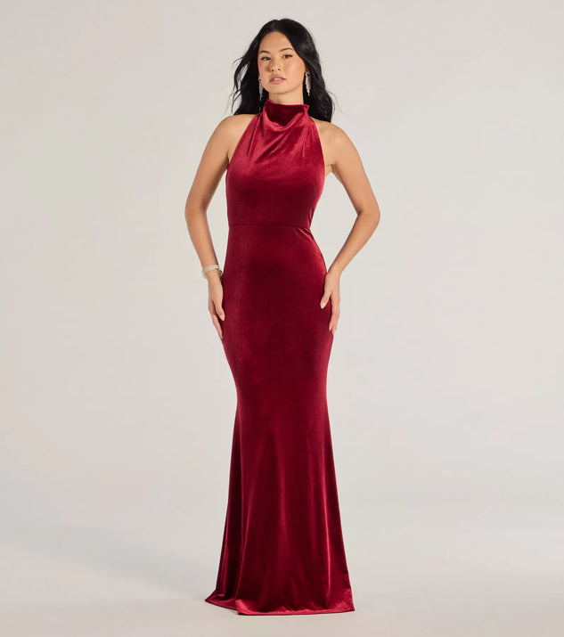 Turn heads at Prom 2025 in this wine prom dress, where statement-making details meet the iconic style of the Nara Long Velvet Halter Mermaid Dress .