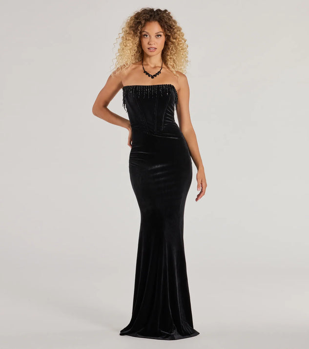 Turn heads at Prom 2025 in this black prom dress, where statement-making details meet the iconic style of the Luisa Pearl Fringe Trim Velvet Corset Mermaid Dress .