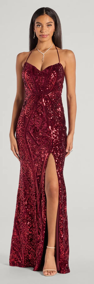 Turn heads at Prom 2025 in this red prom dress, where statement-making details meet the iconic style of the Meara Sequin Velvet Hight Slit Column Dress .