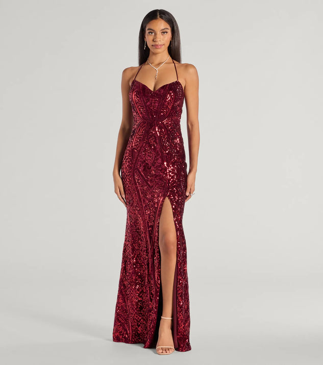 Turn heads at Prom 2025 in this red prom dress, where statement-making details meet the iconic style of the Meara Sequin Velvet Hight Slit Column Dress .