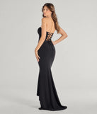 The Marley Lace-Up Mermaid Crepe Formal Dress is a show-stopping black prom dress, offering a sleek, slimming silhouette that enhances your natural beauty for an unforgettable night.
