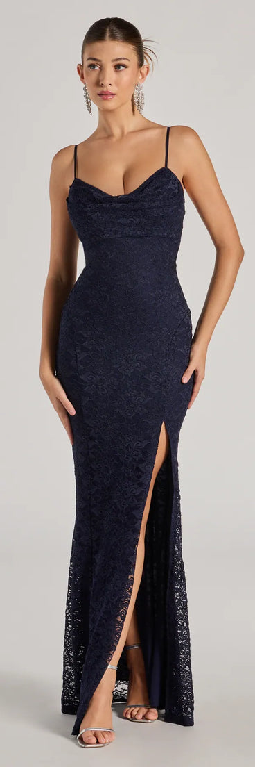 Turn heads at Prom 2025 in this navy blue prom dress, where statement-making details meet the iconic style of the Romina Lace Cowl Neck High Slit Mermaid Dress .