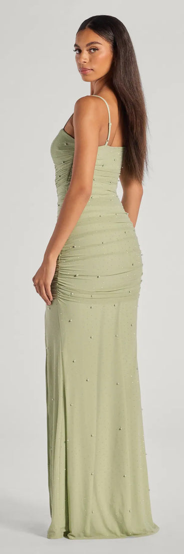 The Annika Pearl And Rhinestone Ruched Mesh Mermaid Dress in sage is a stunning green prom dress designed to capture attention with its fresh or bold color and effortlessly stylish silhouette.
