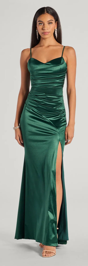Turn heads at Prom 2025 in this hunter green prom dress, where statement-making details meet the iconic style of the Kamari Satin Pleated High Slit Mermaid Dress .
