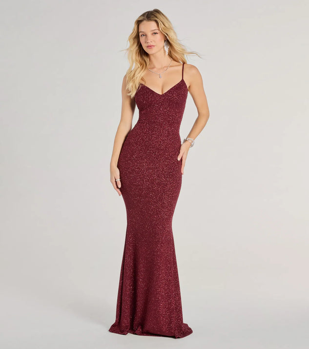 Turn heads at Prom 2025 in this wine prom dress, where statement-making details meet the iconic style of the Tricia V-Neck Open Back Mermaid Glitter Formal Dress .