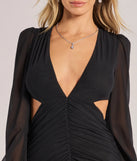 The Adley Long Sleeve Cutout Mesh Formal Dress in luxe black fabric, a stunning prom dress with statement details designed to make a bold impression at Prom 2025.