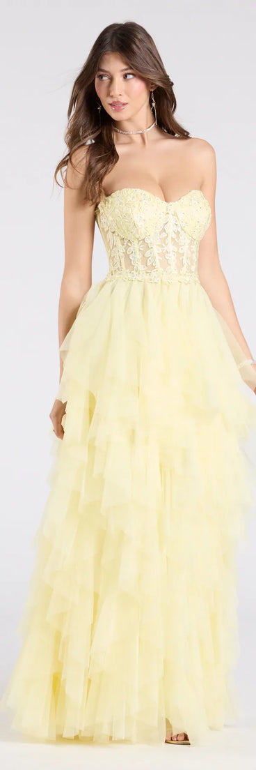 Make a bold statement in the Keyla Floral Applique Tiered Ruffle Tulle Gown in yellow, the perfect summer dress for weddings, cocktail hours, nights out, and/or seasonal celebrations.