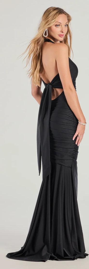The Denise Halter Tie-Back Mermaid Formal Dress is a show-stopping black prom dress, offering a sleek, slimming silhouette that enhances your natural beauty for an unforgettable night.