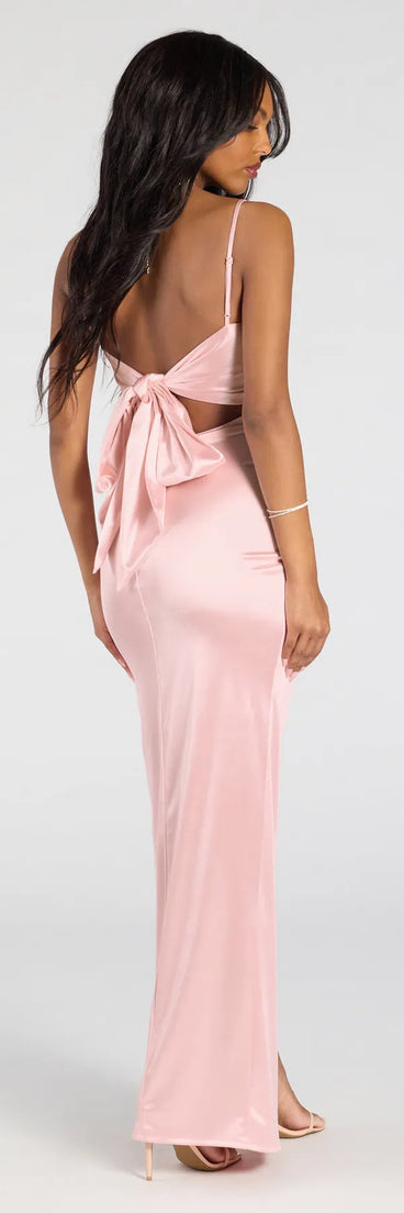 Turn heads at Prom 2025 in this pink prom dress, where statement-making details meet the iconic style of the Carolina High-Slit Bow Wrap Dress.