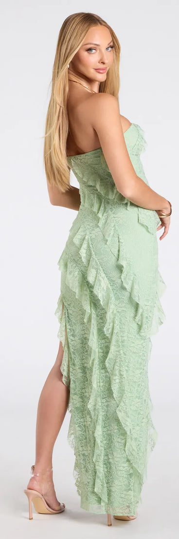 The Ellie Ruffled Lace High Slit Formal Dress in sage is a stunning green prom dress designed to capture attention with its fresh or bold color and effortlessly stylish silhouette.