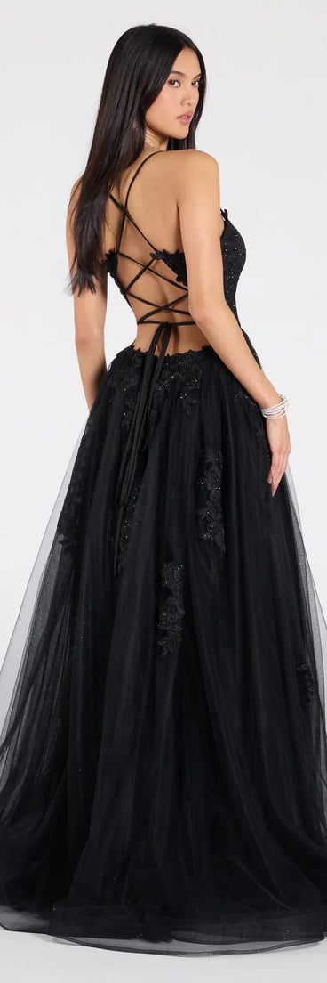 The Julia Lace-Up Corset Slit A-Line Formal Dress is a show-stopping black prom dress, offering a sleek, slimming silhouette that enhances your natural beauty for an unforgettable night.