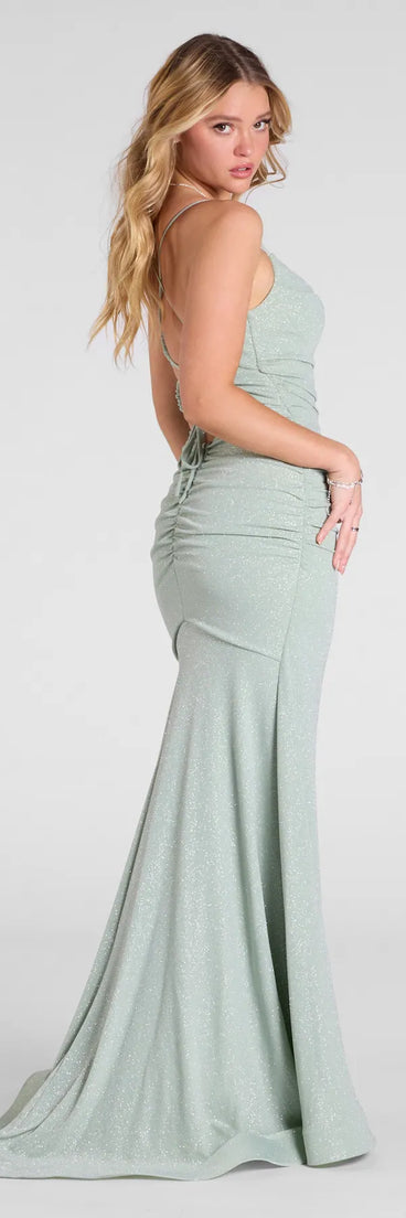 The Leslie Lace-Up Mermaid Glitter Formal Dress in sage is a stunning green prom dress designed to capture attention with its fresh or bold color and effortlessly stylish silhouette.