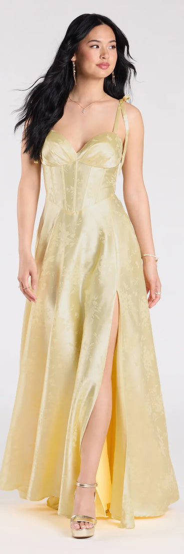 Own the spotlight in the Melika Bustier Slit A-Line Satin Formal Dress, a yellow formal dress crafted to deliver luxe style for autumn weddings, Military Balls, or any special event.