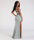 The Ayla Lace-Up Slit Mermaid Glitter Formal Dress in sage is a stunning green prom dress designed to capture attention with its fresh or bold color and effortlessly stylish silhouette.