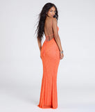 Turn heads at Prom 2025 in this orange prom dress, where statement-making details meet the iconic style of the Kerry Open Back Bodycon Pearl Bead Formal Dress.
