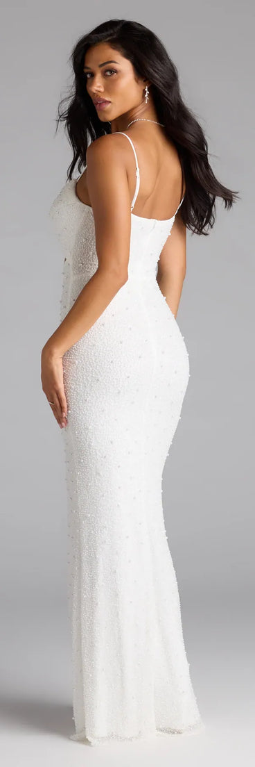 Own the spotlight in the Marine Cutout Slit Mermaid Beaded Formal Dress, a white formal dress crafted to deliver luxe style for autumn weddings, Military Balls, or any special event.