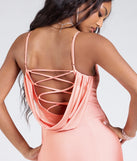 Turn heads at Prom 2025 in this peach prom dress, where statement-making details meet the iconic style of the Lizzie Lace-Up Cowl Back Slit Formal Dress.