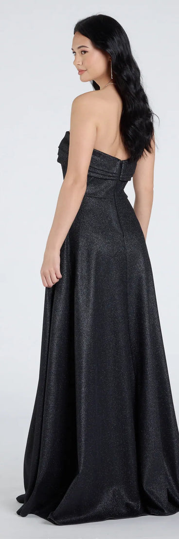 The Peyton Strapless Slit A-Line Glitter Formal Dress is a show-stopping black prom dress, offering a sleek, slimming silhouette that enhances your natural beauty for an unforgettable night.