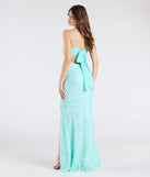 The Dana Tie Back Slit Sequin Formal Dress in mint is a stunning green prom dress designed to capture attention with its fresh or bold color and effortlessly stylish silhouette.