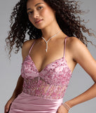 Turn heads at Prom 2025 in this mauve prom dress, where statement-making details meet the iconic style of the Tatianna Lace-Up Applique Slit Satin Formal Dress.