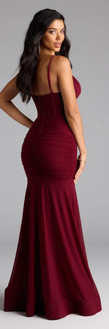 Own the spotlight in the Cesca Corset Slit Mesh Formal Dress, a burgundy formal dress crafted to deliver luxe style for autumn weddings, Military Balls, or any special event.