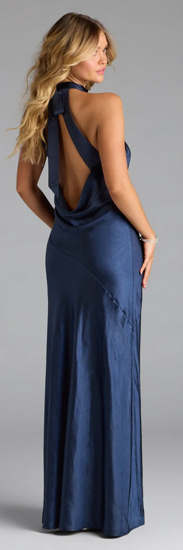 Own the spotlight in the Andie Halter Open Back Slit Satin Formal Dress, a navy blue formal dress crafted to deliver luxe style for autumn weddings, Military Balls, or any special event.