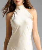 Step into summer looking effortlessly chic in the Andie Halter Open Back Slit Satin Formal Dress in gold, a must-have Windsor dress for your warm-weather wardrobe.