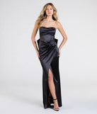 The Mackenzie Strapless Corset Bow Satin Formal Dress is a show-stopping black prom dress, offering a sleek, slimming silhouette that enhances your natural beauty for an unforgettable night.