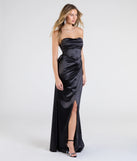 The Mackenzie Strapless Corset Bow Satin Formal Dress is a show-stopping black prom dress, offering a sleek, slimming silhouette that enhances your natural beauty for an unforgettable night.