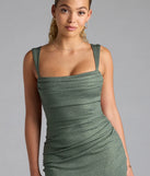 Step into summer looking effortlessly chic in the Catherine Open Back Mermaid Glitter Formal Dress in olive green, a must-have Windsor dress for your warm-weather wardrobe.