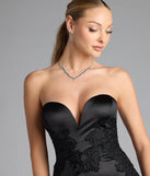 Turn heads at Prom 2025 in this black prom dress, where statement-making details meet the iconic style of the Amari Strapless Applique Mermaid Satin Formal Dress.