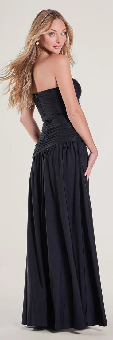 The Lindsey Strapless Slit A-Line Formal Dress is a show-stopping black prom dress, offering a sleek, slimming silhouette that enhances your natural beauty for an unforgettable night.